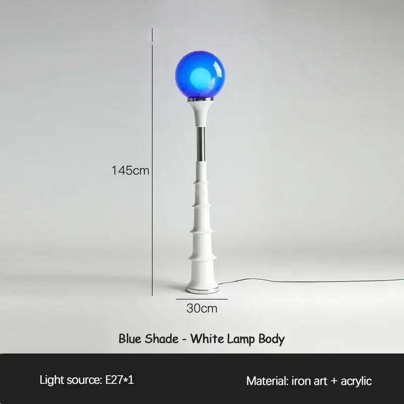 A sleek 145cm tall decorbites colorful memphis floor lamp with a blue acrylic globe shade and white iron art base