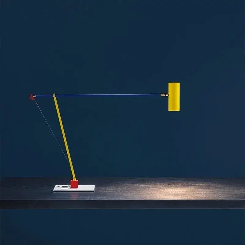 A decorbites colorful metal led adjustable articulated desk lamp in yellow and red with a minimalist white base