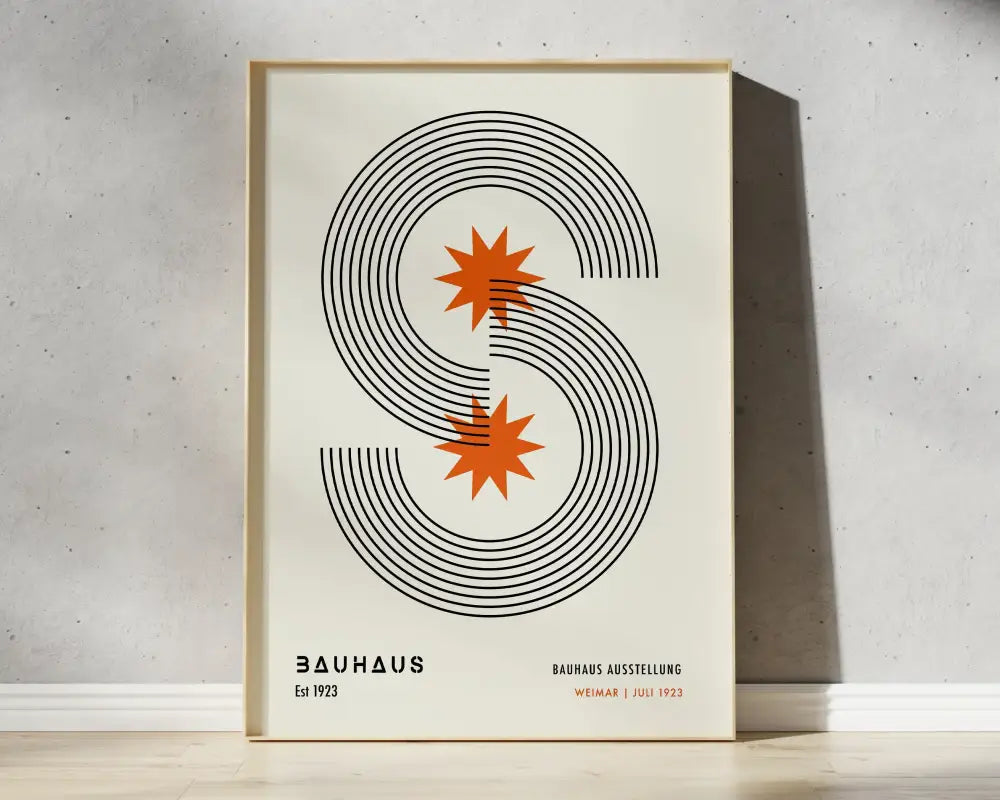 A minimalist framed poster with bold black mid century geometric s and orange starburst accents by DecorBites™