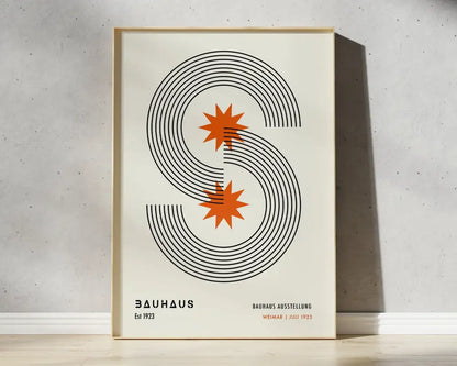 A minimalist framed poster with bold black mid century geometric s and orange starburst accents by DecorBites™