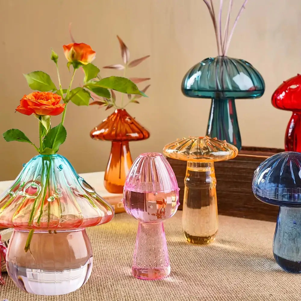 DecorBites™ colorful mushroom vase made of translucent glass with a blue to pink gradient holding orange roses
