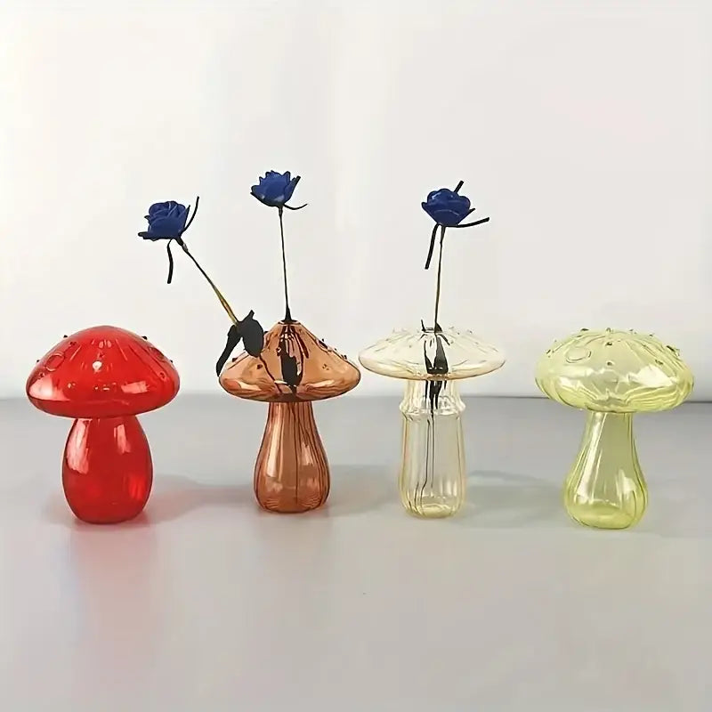 Set of four colorful mushroom vases in red copper clear and yellow-green glass with textured caps holding blue roses