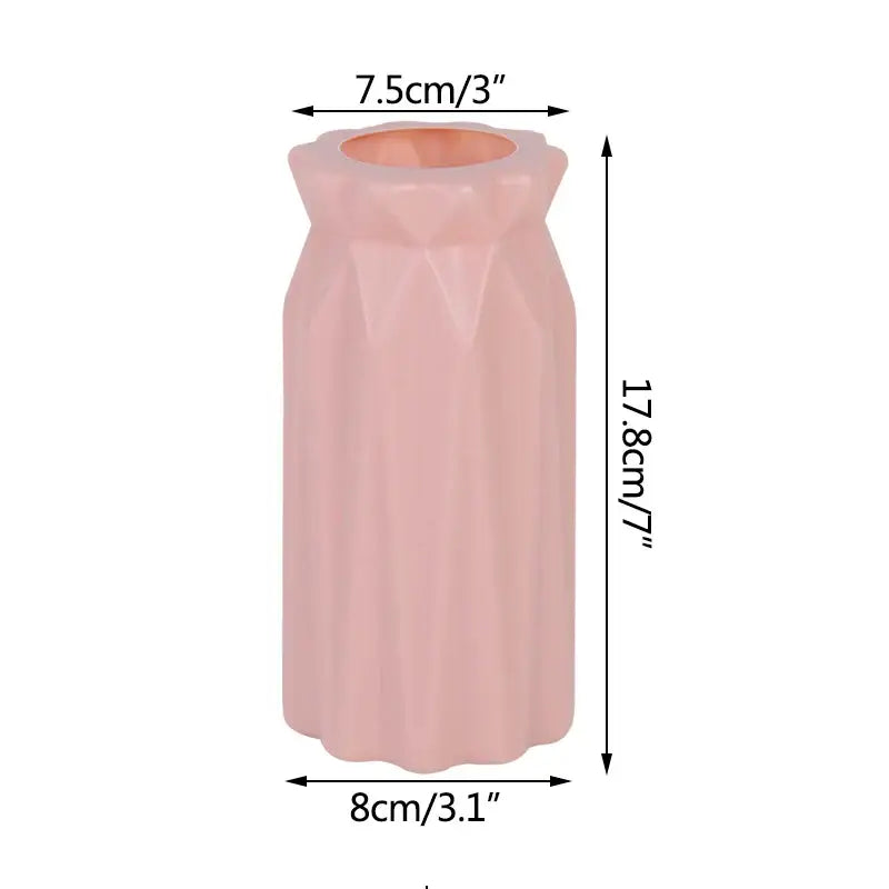 A sleek blush-pink ceramic modern flower vase with faceted geometric design and fluted rim for home décor