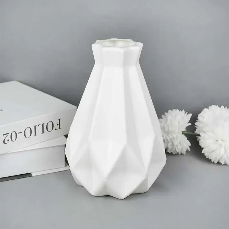 A sleek white ceramic modern flower vase with a geometric faceted design from decorbites colorful plastic flower vase collection
