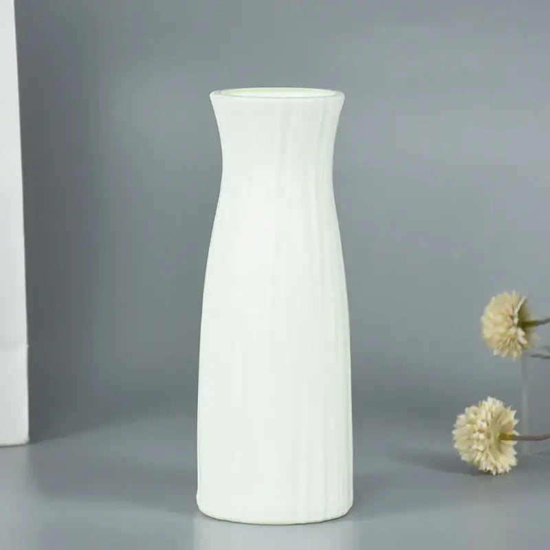 A sleek white ceramic modern flower vase with vertical ridges and flared rim for home décor by decorbites