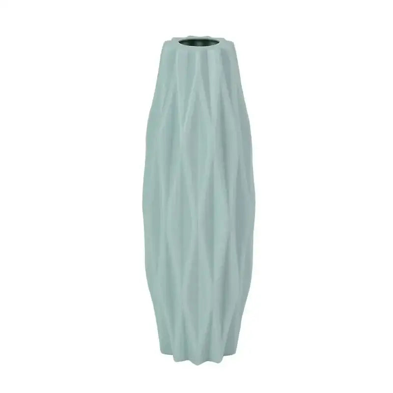 A tall slender light blue ceramic flower vase with textured ribbed surface and flared base by DecorBites™