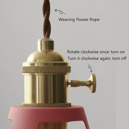 Brass-finished vintage-style lamp socket with textured knob attached to brown twisted rope for colorful retro pendant lights by decorbites