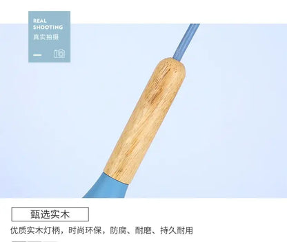 A light brown wooden handle with smooth natural grain and blue plastic grip in colorful retro pendant lights by decorbites