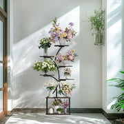 DecorBites™ compact tree design black metal plant stand with multiple curved shelves displaying colorful floral arrangements