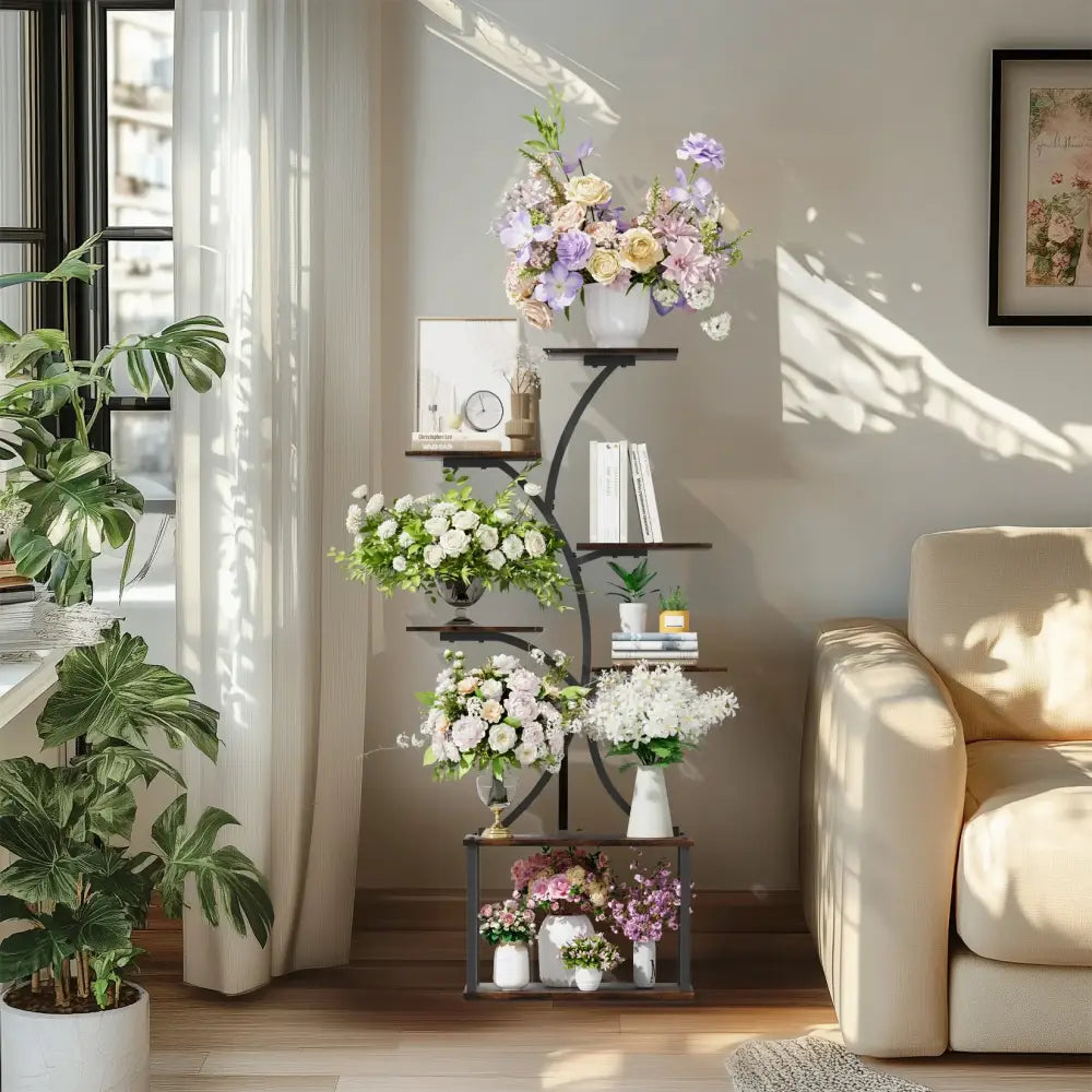 DecorBites compact tree design black wrought iron plant stand with multiple curved shelves holding floral arrangements