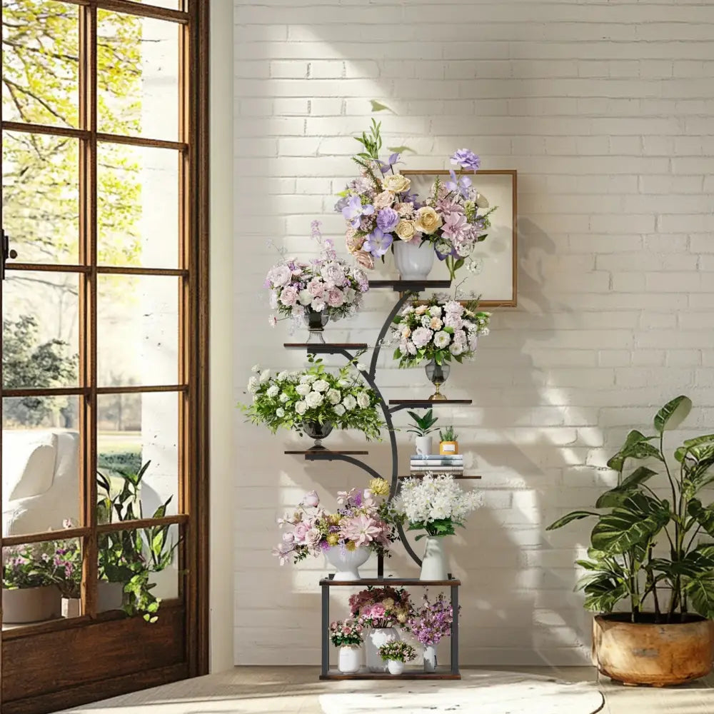 Black wrought iron decorbites compact tree design plant stand with multiple shelves holding vases of flowers