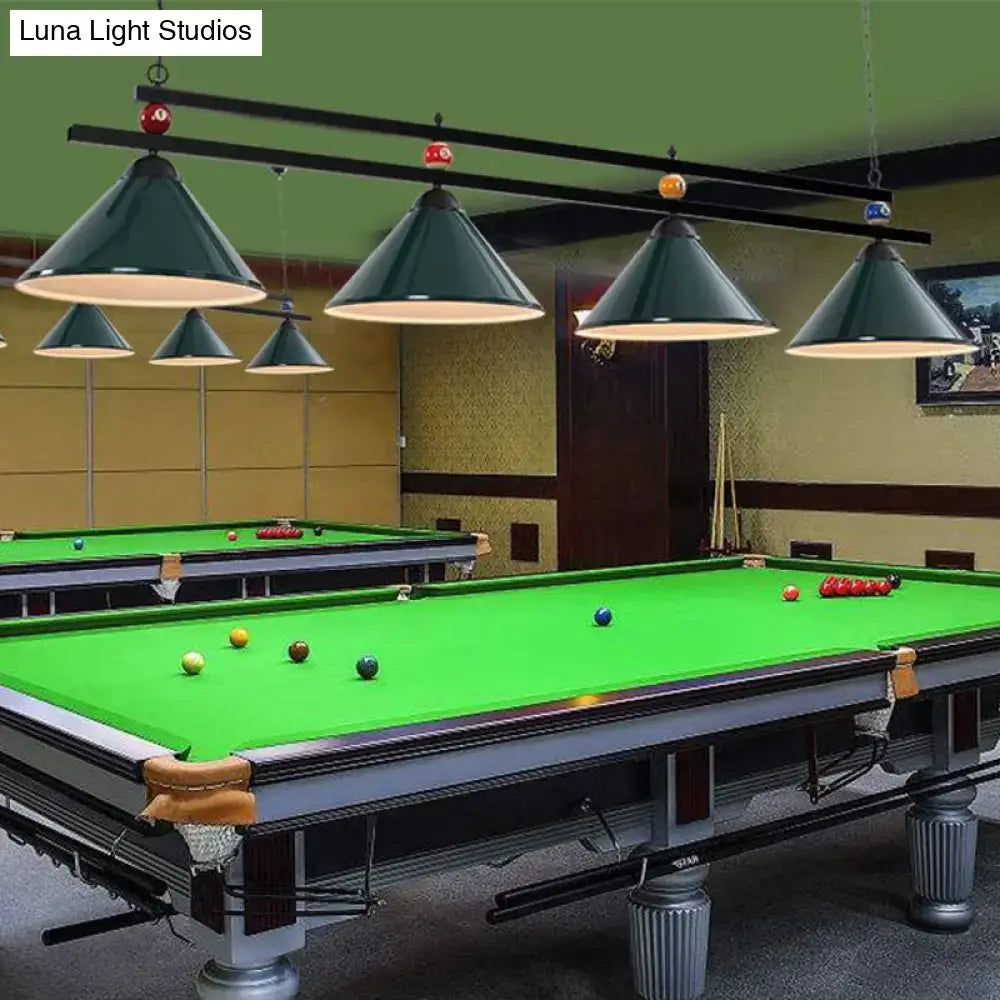 Dark green conical metal pendant ceiling lights with brass accents hang above a pool table for industrial decor