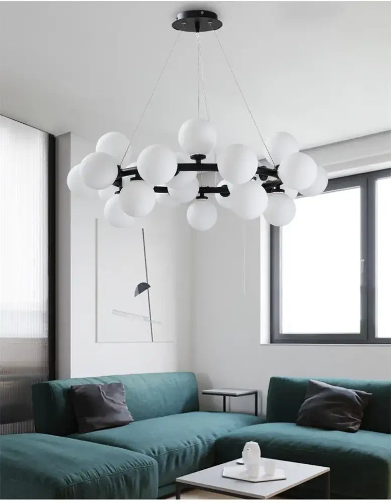 DecorBites™ contemporary black and gold chandelier featuring numerous frosted white glass ball globes