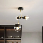 DecorBites™ contemporary black and brass hourglass semi flush mount ceiling light with three bulbs and clear glass shade