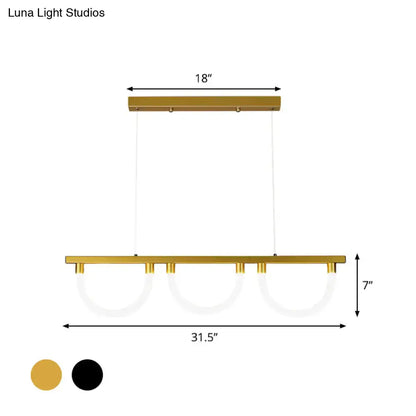 Gold-finished contemporary island lamp with three circular acrylic glass shades suspended by thin cords for kitchen island