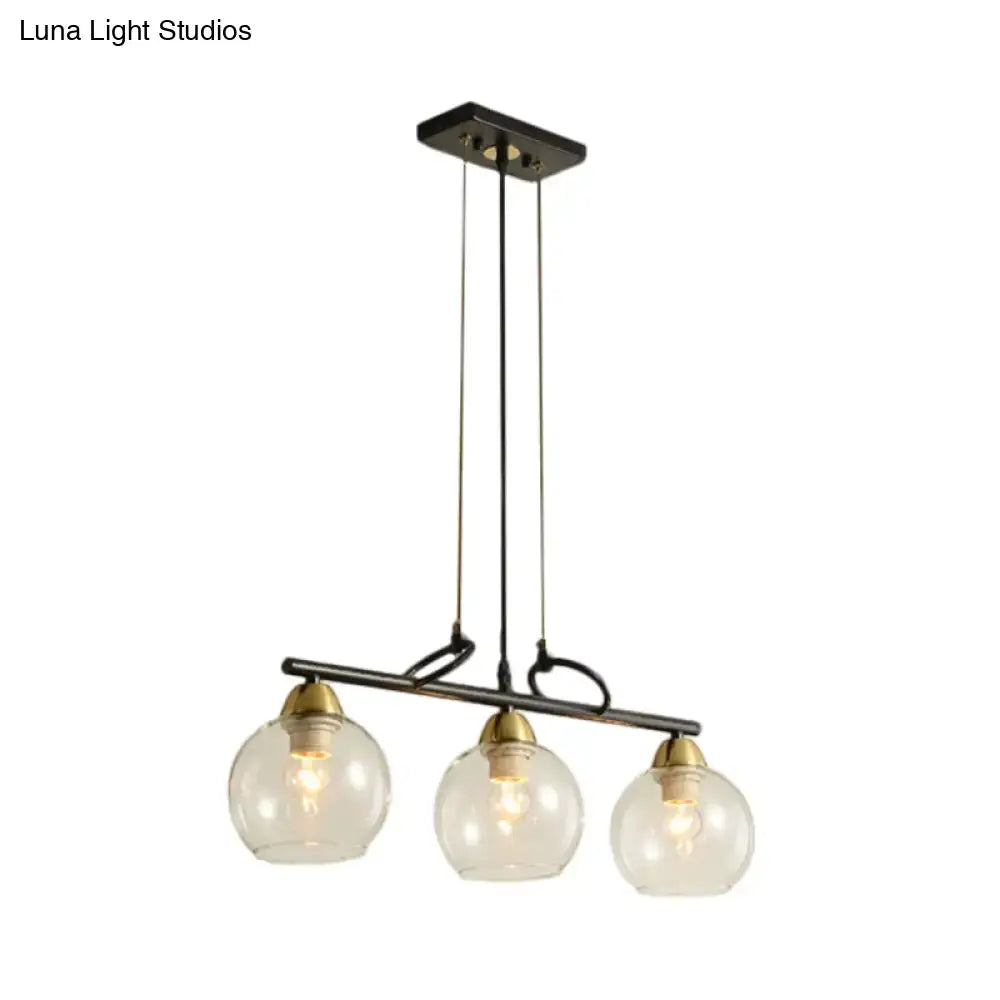 DecorBites™ black metal chandelier with three clear prismatic glass globes and brass accents for dining hall lighting