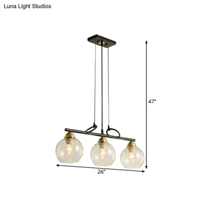 DecorBites™ contemporary black metal pendant light with three clear prismatic glass globes and brass accents for dining hall