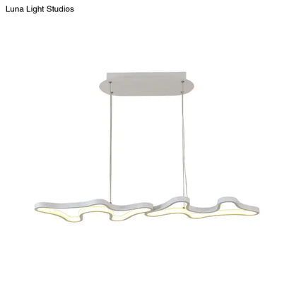 Modern white led island light with sleek wave design and chrome metal suspension cords in black white DecorBites™ style