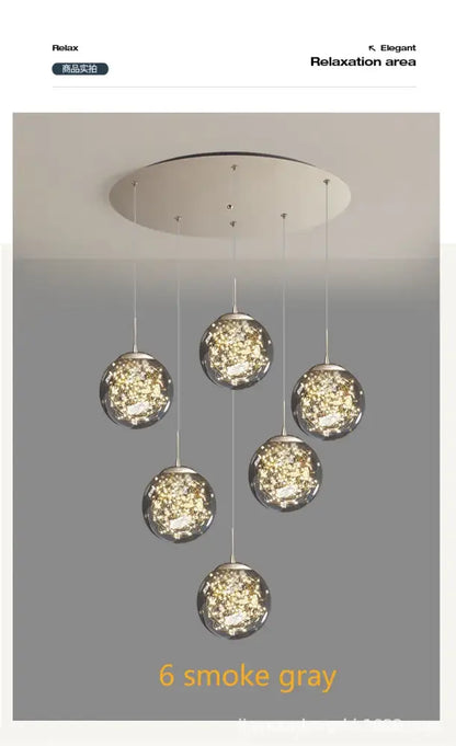 Six smoke gray crystal ball glass pendant lights hang from a circular fixture in this DecorBites modern spiral chandelier