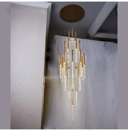 Gold-toned DecorBites™ contemporary crystal chandelier with clear cylindrical glass elements for large staircase lighting