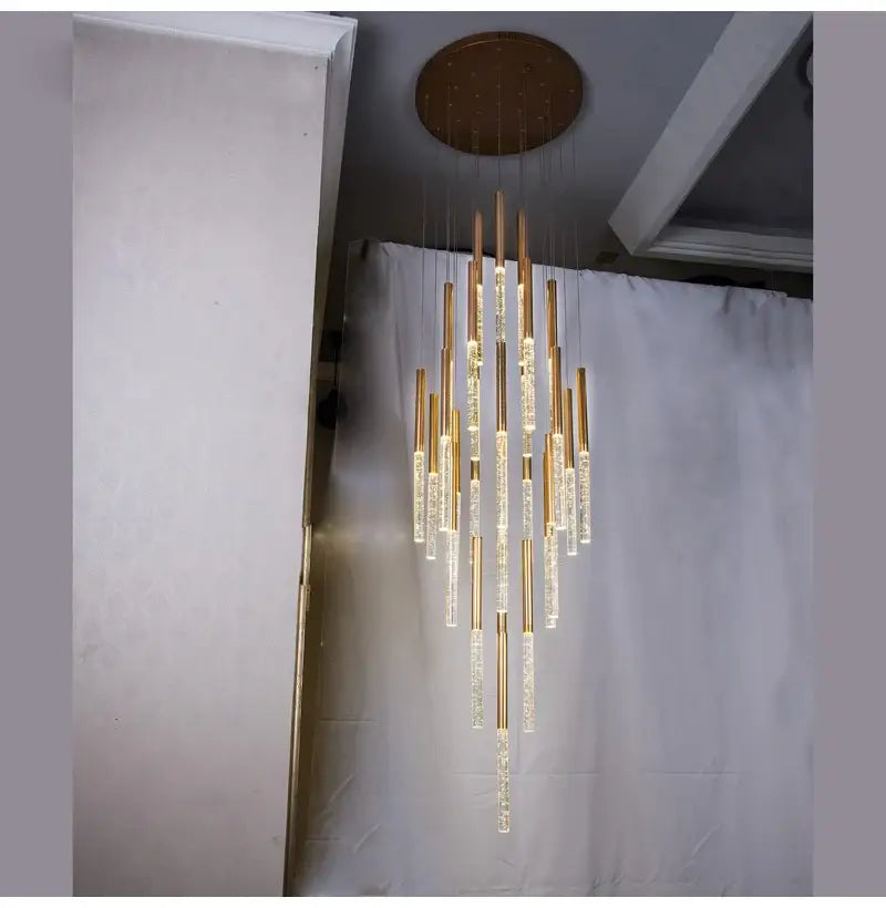 Gold-toned DecorBites™ contemporary crystal chandelier with clear cylindrical glass elements for large staircase lighting