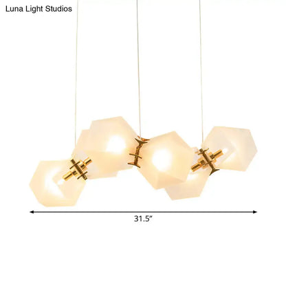 Modern hexagonal pendant honeycomb island lamp with frosted white glass shades and brass accents for living room use