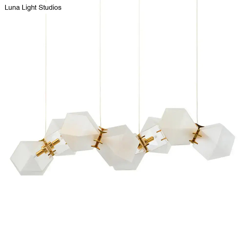 Modern white hexagonal pendant light fixture with frosted white glass and gold-toned metal for honeycomb island lamp use