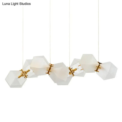 Modern white hexagonal pendant light fixture with frosted white glass and gold-toned metal for honeycomb island lamp use