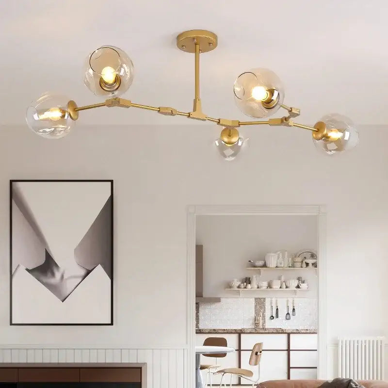 Gold-toned decorbites contemporary glass bubble chandelier with five clear glass globe shades for living room lighting