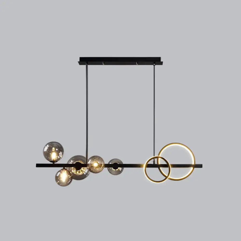 Modern black metal island lamp with smoke grey glass spheres and gold rings for dining room by DecorBites™