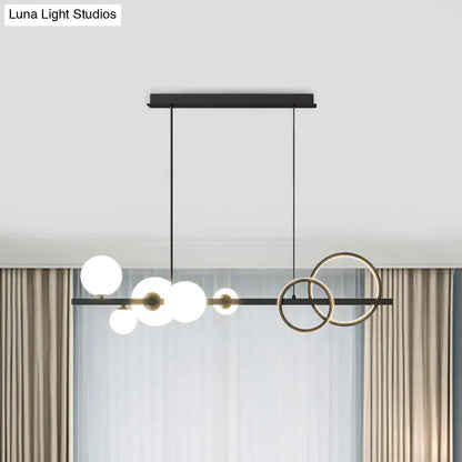 Modern black and brass decorbites island lamp with milk white glass bulbs and smoke grey circular rings for dining room
