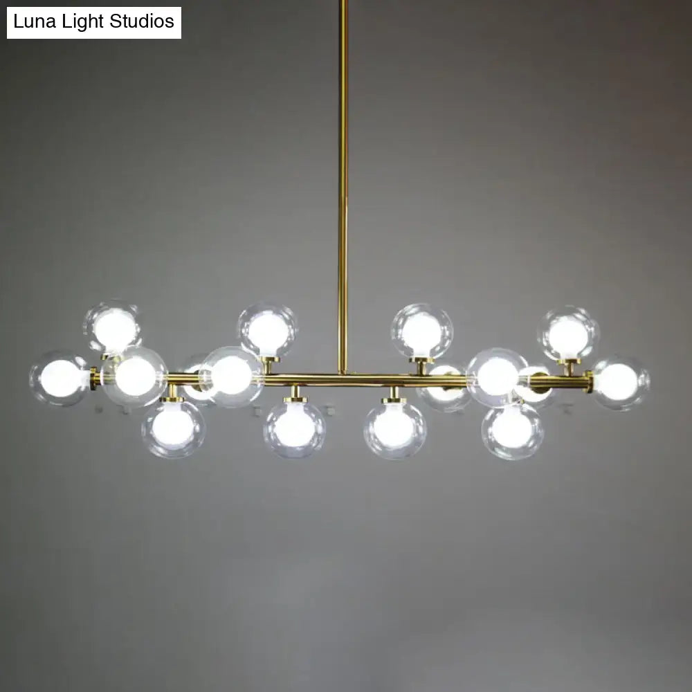 Modern brass DecorBites™ chandelier with clear glass globe bulbs in a linear design for living room ceiling lighting