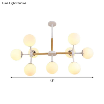 Modern chandelier with a wooden crossbar white glass globe shades and metal arms ideal for dining room hanging light