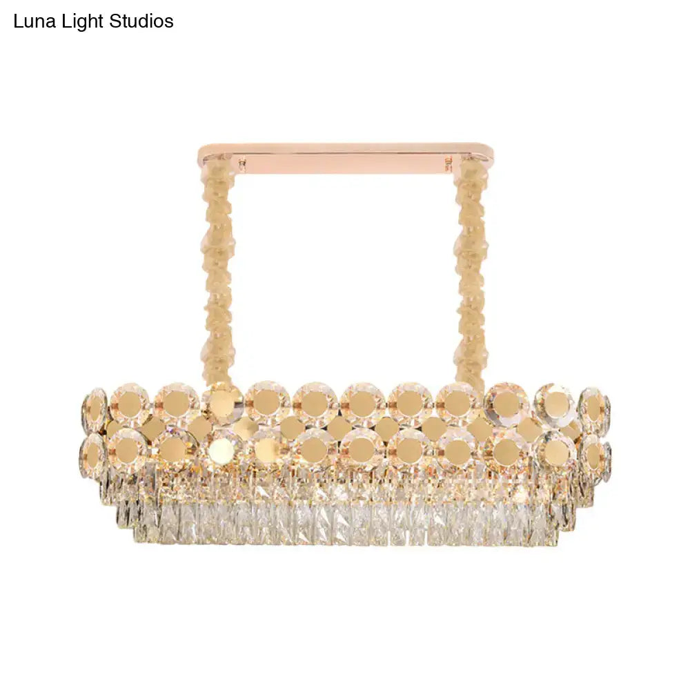 Rose gold DecorBites island pendant with cascading clear crystal blocks and polished brass accents for dining halls