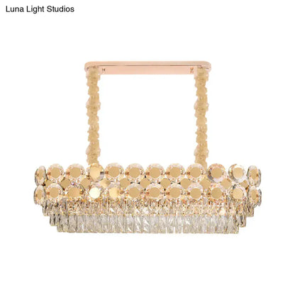 Rose gold DecorBites island pendant with cascading clear crystal blocks and polished brass accents for dining halls