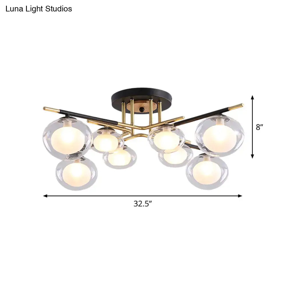 Modern semi-flush mount ceiling light with black base, gold metal arms, and clear glass oval shade globes for dining room