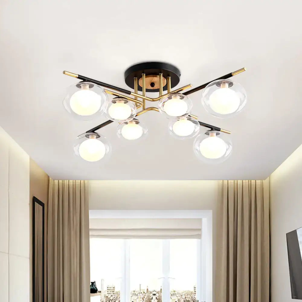 Modern semi-flush mount ceiling fixture with six clear glass globes on black and gold metal arms and oval shade