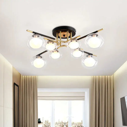 Modern semi-flush mount ceiling fixture with six clear glass globes on black and gold metal arms and oval shade