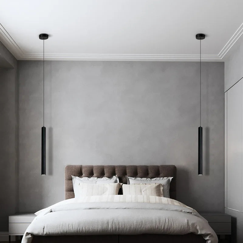 Two sleek black DecorBites™ contemporary nordic led pendant lights hang symmetrically above a bed