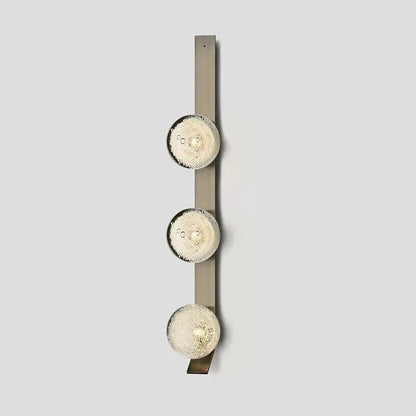 Decorbites™ contemporary wall light featuring three frosted glass globes on a brushed metal vertical bar fixture