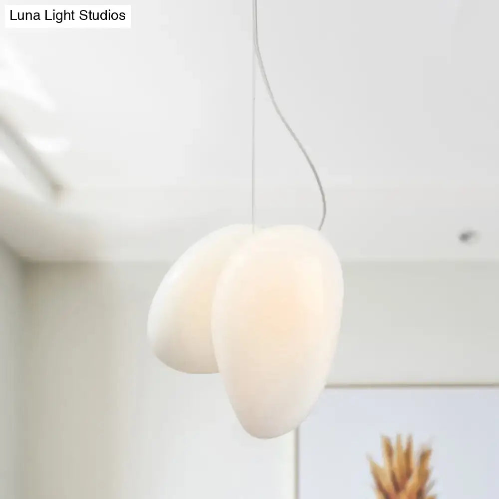 Cream-colored creamBites™ white glass pendant light with smooth matte finish and organic egg shape for dining rooms