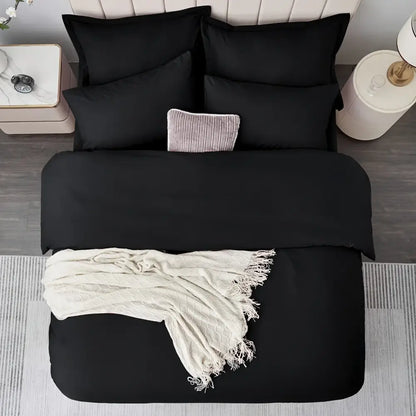 Black satin-like cotton duvet cover set with matching pillows and cream textured throw from DecorBites™ cooling summer collection