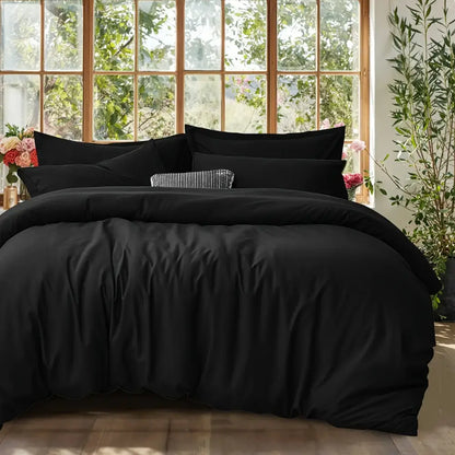 DecorBites™ black satin-like cotton duvet cover set with matching pillows and a textured accent pillow in center