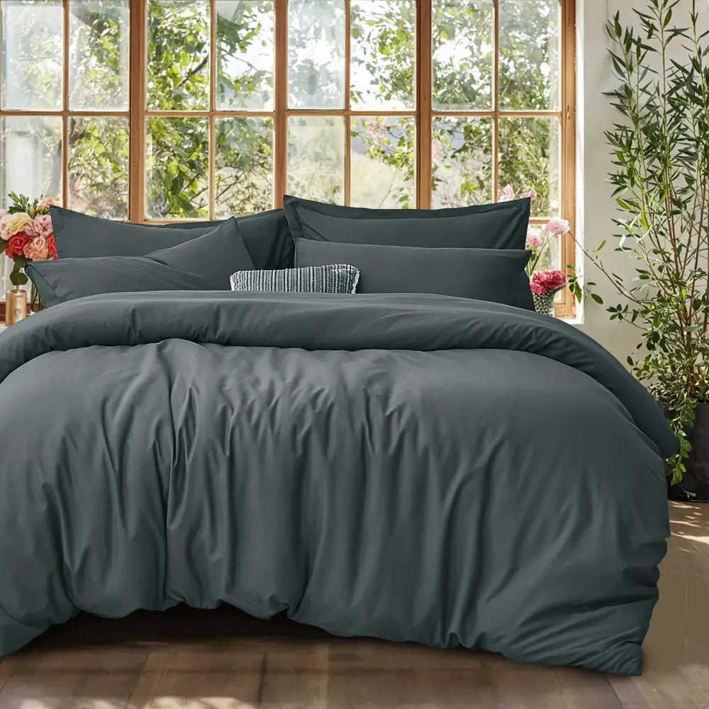 Dark teal satin cotton duvet cover set with matching pillowcases featuring subtle sheen and soft texture for summer use