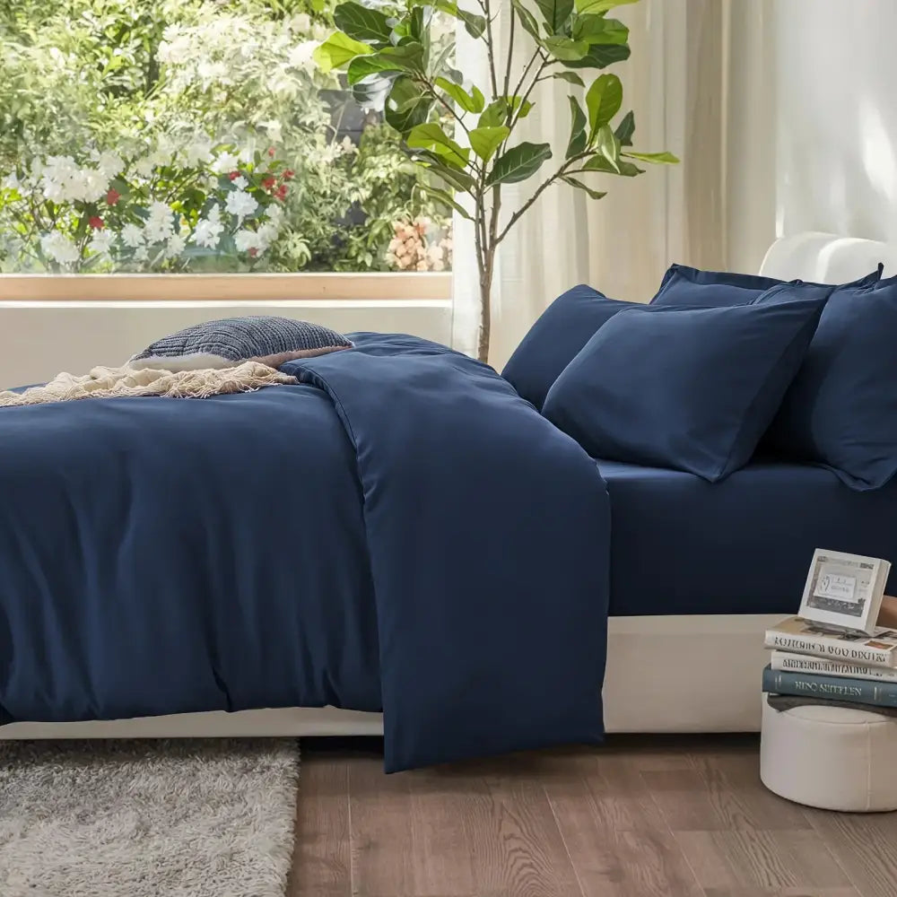 Deep navy blue satin duvet cover set with matching pillowcases featuring soft smooth texture by DecorBites cotton duvet