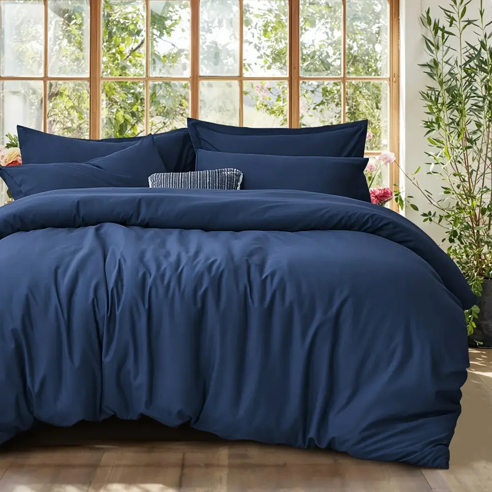 Deep navy blue decorbites™ cooling summer cotton duvet cover set with matching pillows features smooth soft fabric and subtle stitching