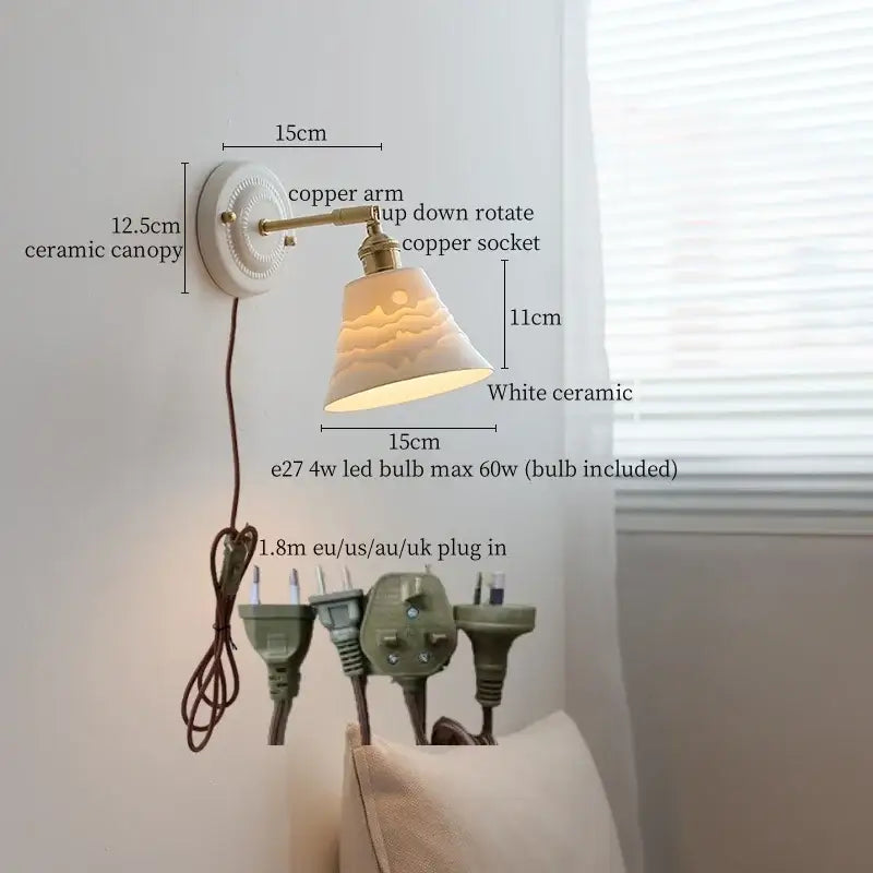 White ceramic wall lamp with decorbites copper arm and bell-shaped shade softly diffusing warm bedroom light
