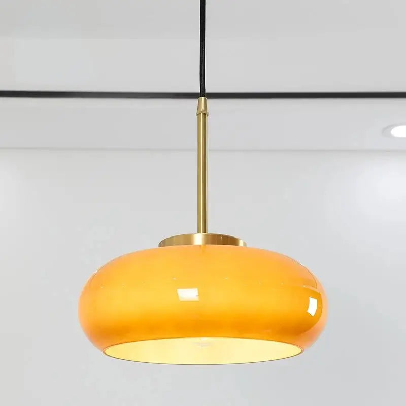 DecorBites™ copper pendant light with sleek amber glass shade, brass stem, and black cord for elegant lighting