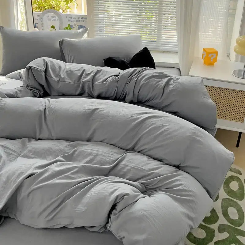 DecorBites™ gray cotton bedding set with duvet cover and matching pillows featuring a soft, slightly wrinkled texture