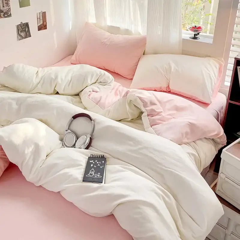 Soft white and blush pink cotton bedding set with duvet cover featuring a cozy layered look by decorbites